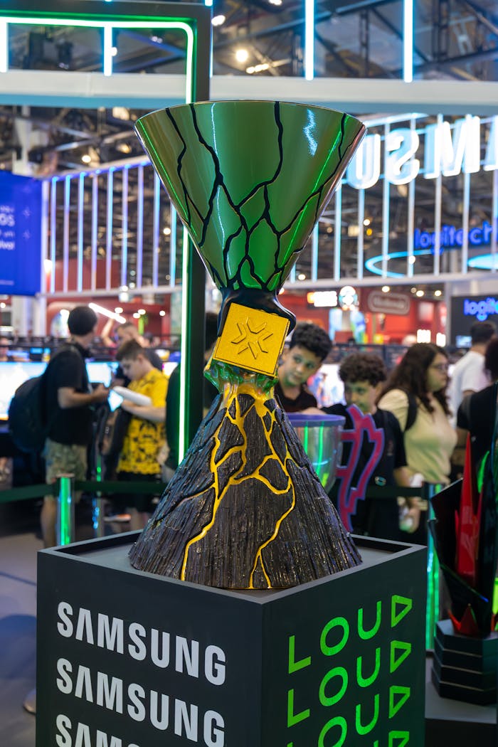 Vibrant gaming trophy showcased at a tech event with Samsung branding.